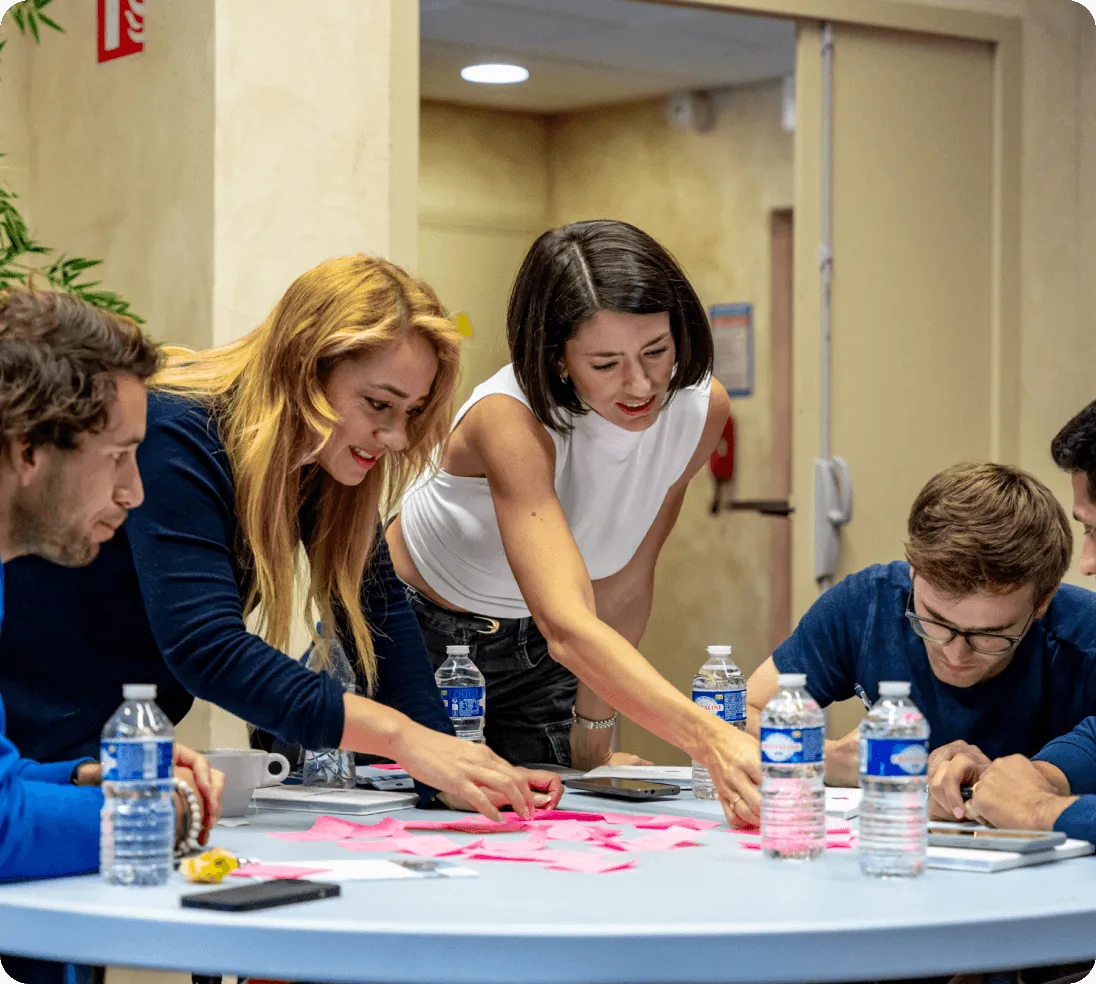 A group of people sitting around a table.